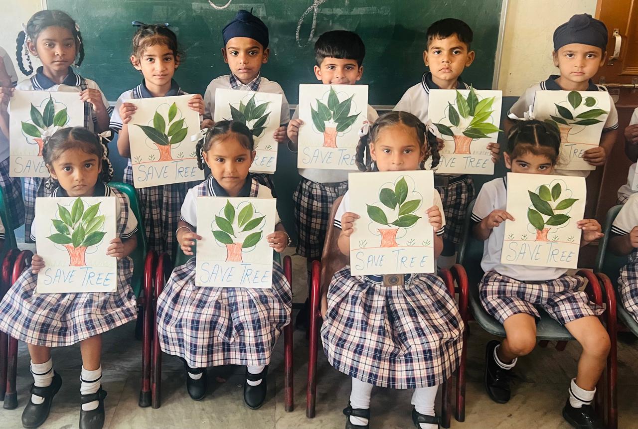 Primary students with Save Tree posters